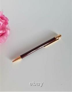 Cartier ballpoint pen, burgundy colour. Trinity collection. Boxed