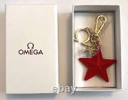 Omega cream & rose gold pen with free Omega handbag charm in original boxes